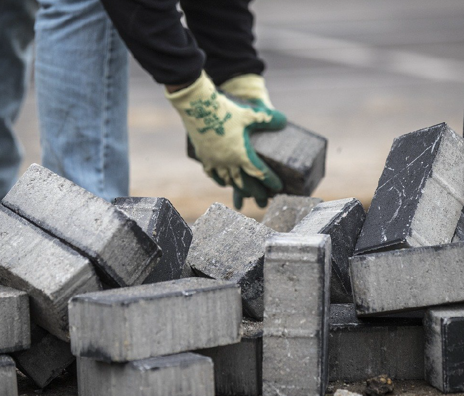 A bricklayer using cement. 